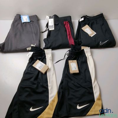 a group of men ' s nike pants sitting on top of a table