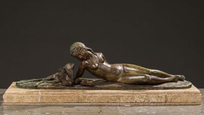 bronze sculpture of a woman laying on a marble base