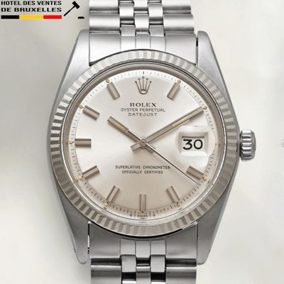 a close up of a watch with a white dial on a bracelet