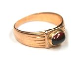 an image of a gold ring with a red stone in the center