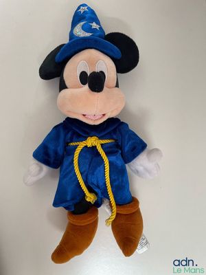 mickey mouse dressed as a wizard with a blue hat and blue robe
