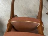 a wooden chair with a brown seat and a brown cushion