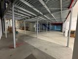 a large empty warehouse with a lot of steel beams