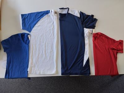 several shirts are laid out on the floor next to each other