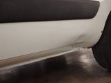 a close up of a tire on the side of a white truck