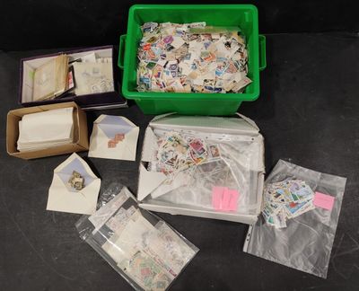a green container filled with lots of stamps on a table