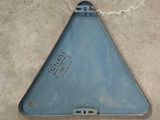 a blue triangle shaped object on the floor of a building