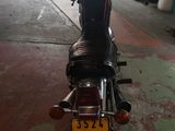 a motorcycle parked in a garage with a number plate on it