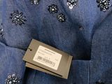 a close up of a blue shirt with sequins on it