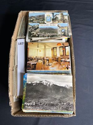 a cardboard box full of postcards with pictures in it