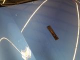 a close up of the hood of a car with a sticker on it