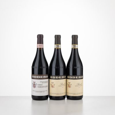 three bottles of red wine are lined up on a table