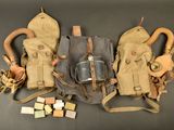 three gas masks, a gas mask, and a gas mask are laid out on a table