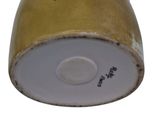 a close up view of a gold and white vase