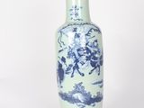 a blue and white vase sitting on a white surface