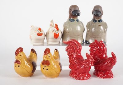 five figurines of chickens and roosters sitting on a shelf