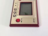 a red and silver electronic device on a white surface