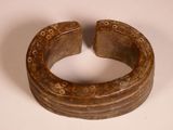 a wooden ring with holes in it on a white surface