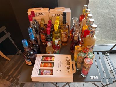 many bottles of alcohol sitting on a table next to a book