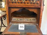 a small wooden cabinet with a drawer on top of it