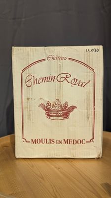 a box of wine sitting on top of a wooden table