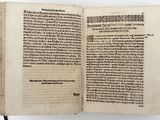 an open book on a table with writing on it