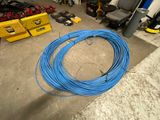 a blue wire that is on the ground in a garage