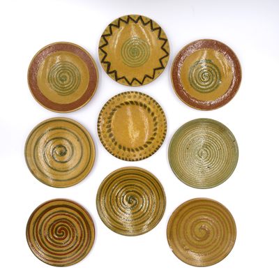 several plates are arranged in a circle on a white surface