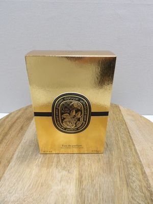 an image of a box of perfume sitting on a wooden table