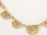 a close up of a gold necklace on a mannequin mannequin mannequin mannequin mannequin mannequin mannequin manne