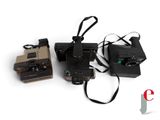 three cameras that are sitting next to each other on a table
