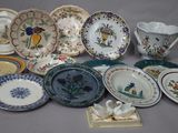 many different plates and cups on the table