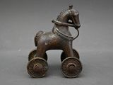bronze figurine of a horse with a rider on it ' s back