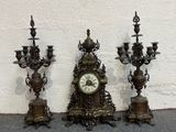 three antique clocks sitting next to each other on the floor