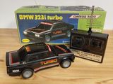 a black toy truck with a radio on top of it