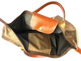 a brown and tan bag with a brown handle