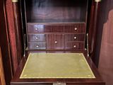 a wooden desk with a marble top in a room