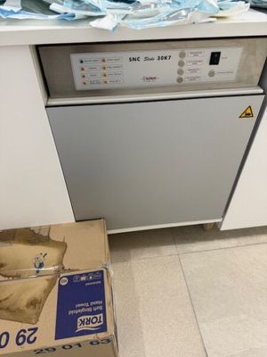 a box that is sitting on the floor in front of a dishwasher