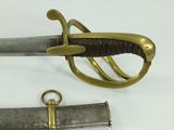 two swords that are laying side by side on a table