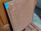 a wooden chair with a seat that has been painted brown