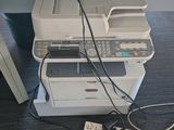 a white printer sitting on top of a desk next to a power strip