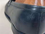a close up of a pair of black shoes with a wooden heel