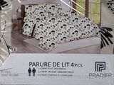 a picture of a bed with a black and white floral pattern on it