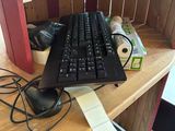 a computer keyboard and mouse on a desk with a printer