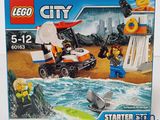 a box with a lego city set in it on a table