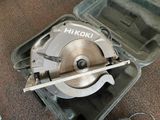 someone is using a circular saw to cut a piece of wood with a circular saw