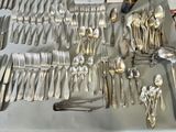a lot of silver spoons and forks on a table