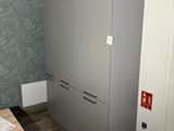 a refrigerator in the corner of a room next to a table