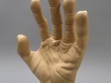 a clay hand that is sitting on a table