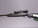 un gros plan d'un fusil sur fond blanc, avec une arme à feu au premier plan